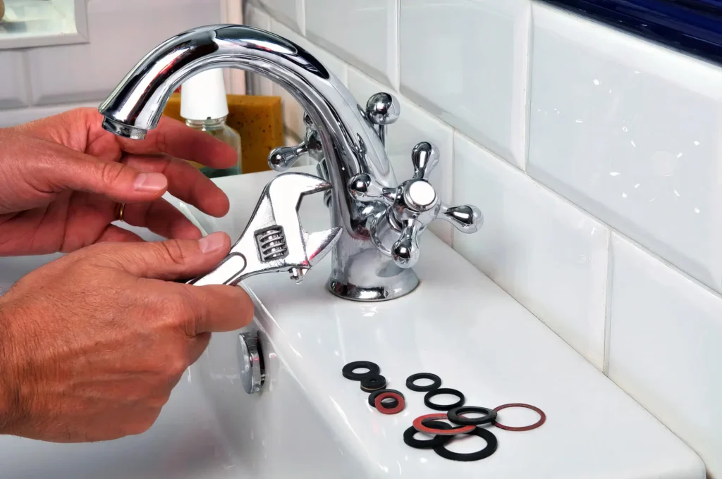 Plumber performing maintenance on a bathroom faucet in North Port