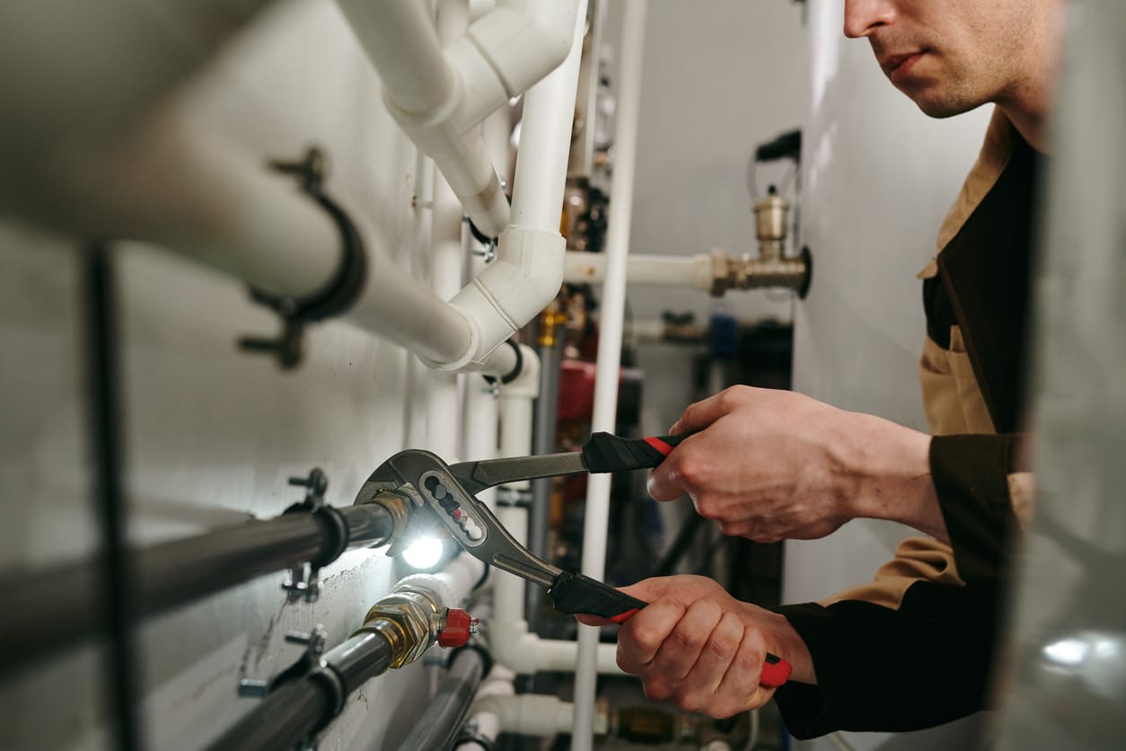 Plumbers maintaining commercial plumbing pipes in North Port