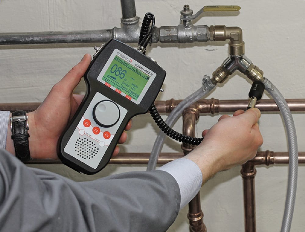 Plumber testing pipes with electronic leak detection equipment in North Port