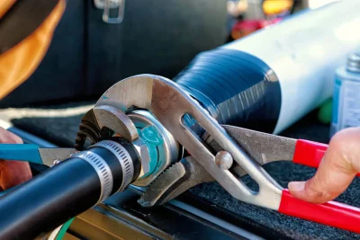 Technician tightening an industrial pipe connection in North Port