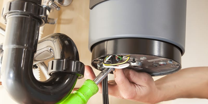 Technician repairing the heating element of a water heater in North Port