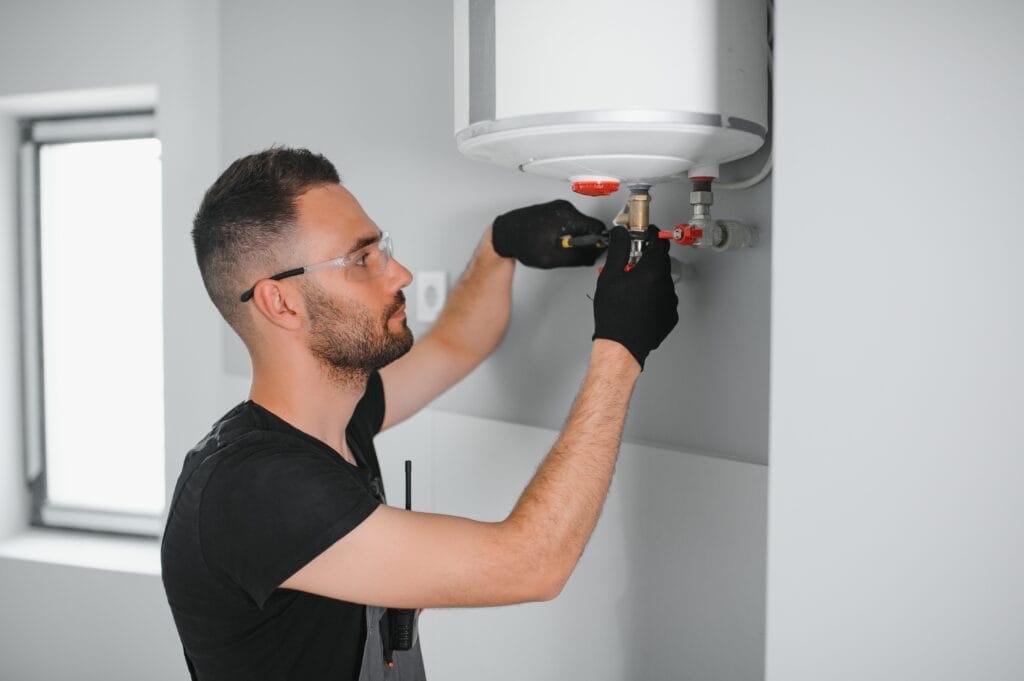 Technician performing water heater maintenance in North Port
