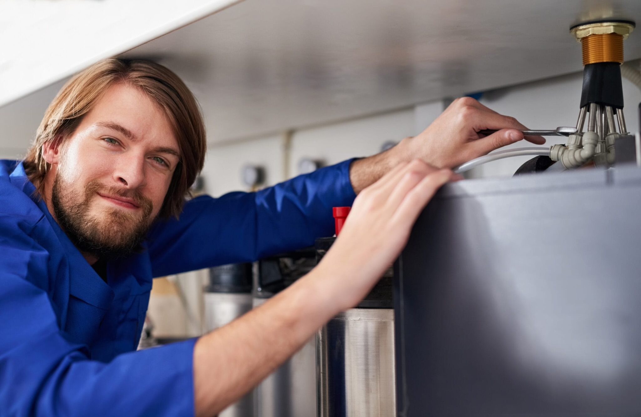 Technician servicing a residential water heater tank in North Port