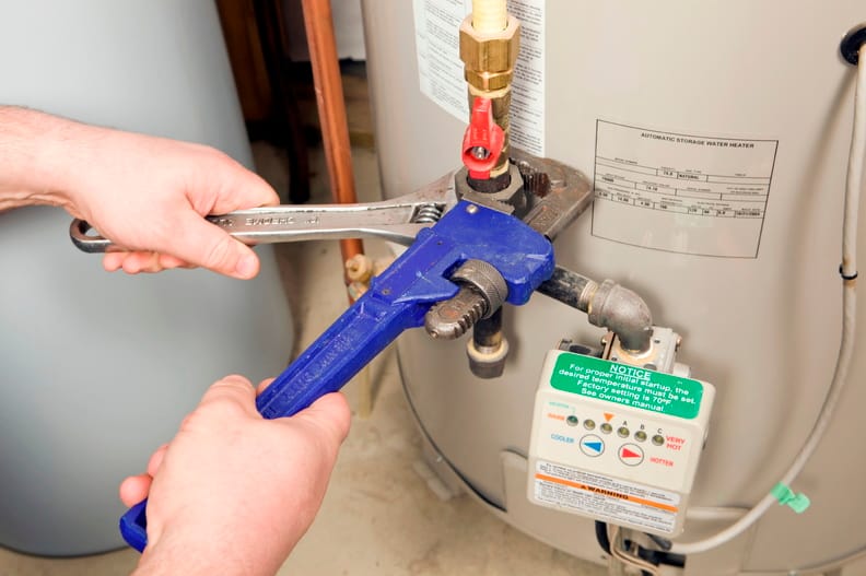 Plumber repairing a water heater valve in North Port